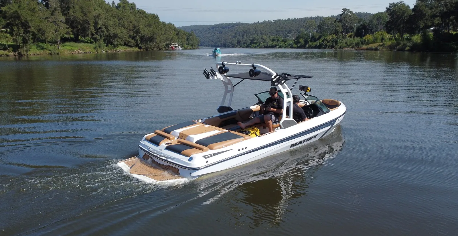 White MXV under way, swim platform and tower in view